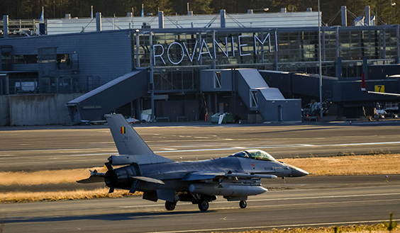 Fighter on the runway, in the background a big sign that reads: Rovaniemi