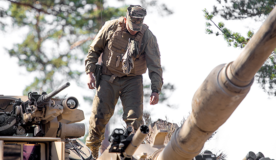 A soldier on top of a tank