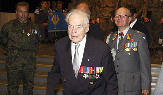 man in a dark suit with decorations