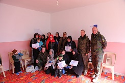Local civilians and two soldiers holding paper notes 