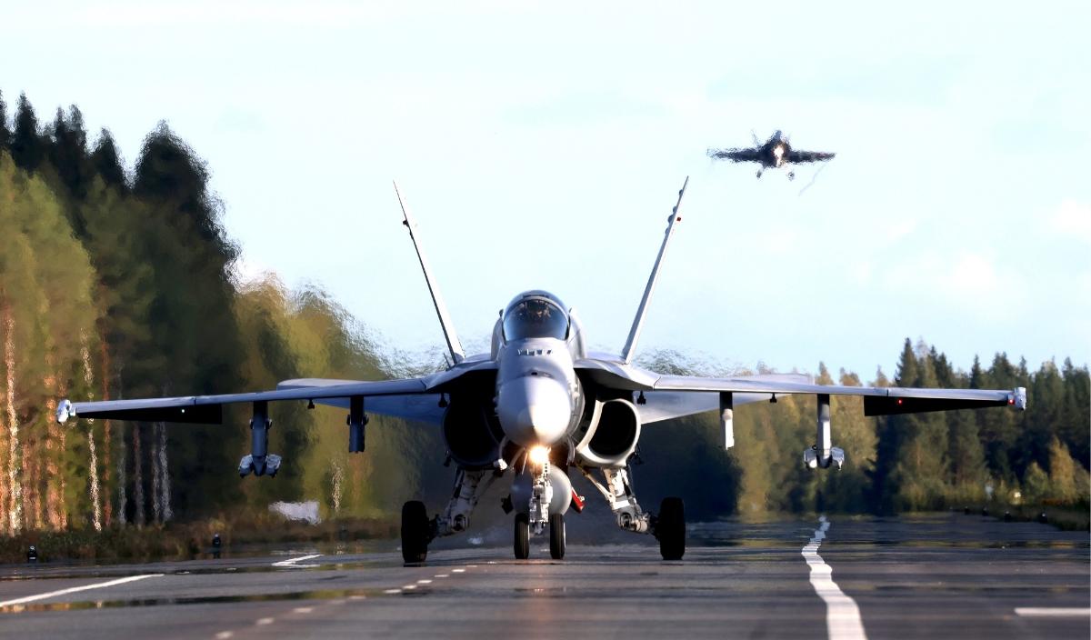 Hornet-hävittäjä on laskeutunut maantietukikohtaan ja toinen kone on laskeutumassa.