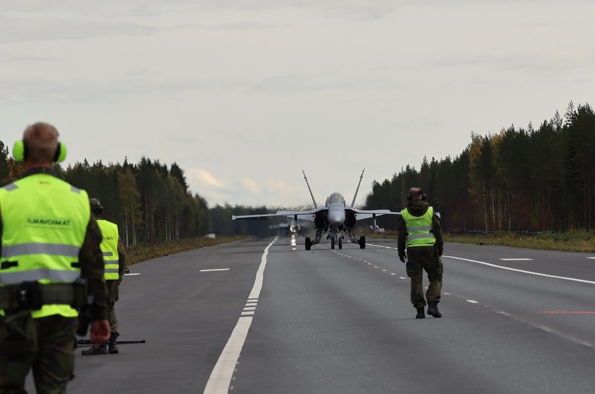 Hornet Fighter has landed to a road base and personnel.