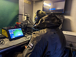 A Navy diver tests an underwater robot, the ROV.