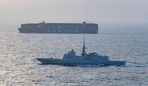 Warship and a commercial ship at sea. Photo: EUNAVFOR ASPIDES