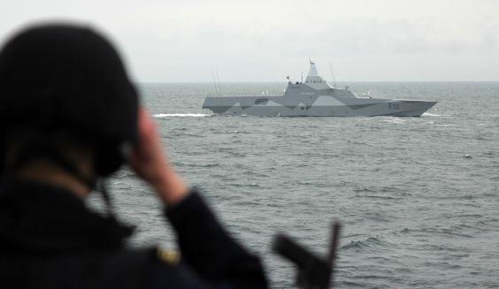 A Swedish warship in the horizon seen from a Finnish vessel.