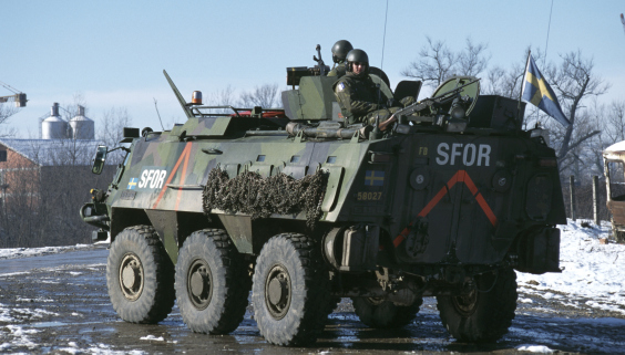 Armoured personnel carrier XA-180. Two men shown on top of the vehicule.